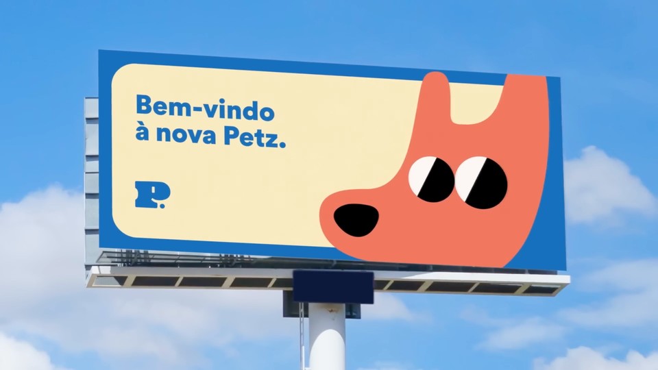 A Petz billboard against a blue sky, featuring the new red dog character and the original Portuguese welcome message.